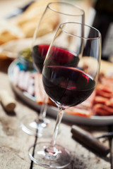 Red wine with charcuterie assortment on the background