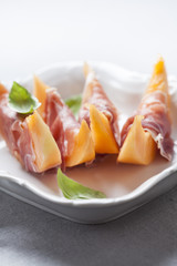 Slices of cantaloupe melon and prosciutto ham, shallow DOF