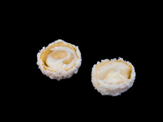 Raffaello white candy with coconut flakes on a black background