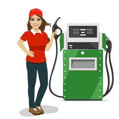 Female gas station worker holding petrol pump standing next to fuel dispenser
