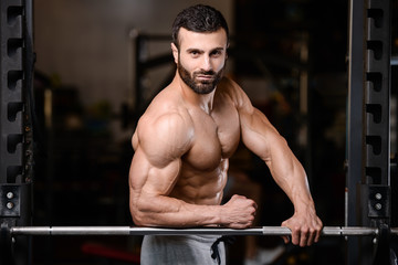 Fototapeta na wymiar Caucasian sexy fitness male model execute exercise with barbell