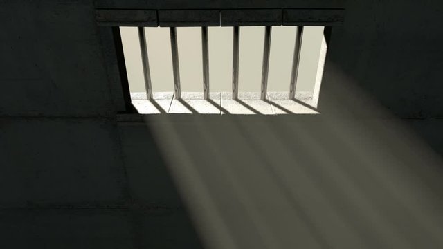 A  24 hour time-lapse from inside an empty dark jail cell with light rays penetrating the barred window