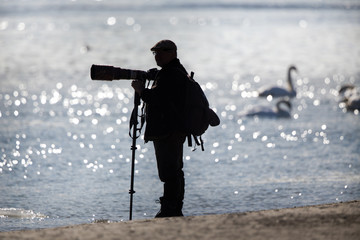 Nature photographer on river coast
