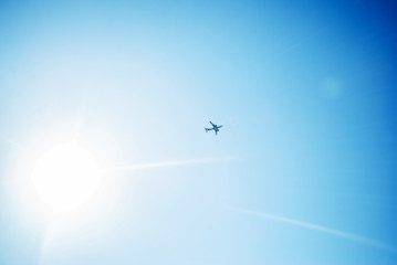 Plane crossing a cloud vignette and sun