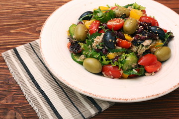 Tuna salad with cherry tomatoes, beans and olives. Low fat eating concept.