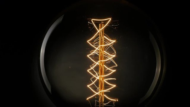 Vintage Edison light bulb on black background