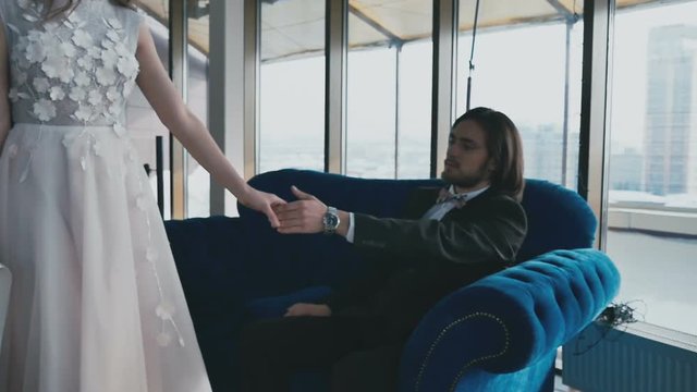 The bride and groom take each other's hands in slow-motion