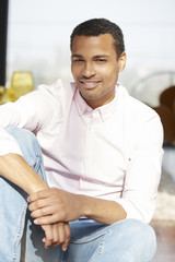 Confident young man portrait. Shot of a young Afro American man sitting at home and relaxing.