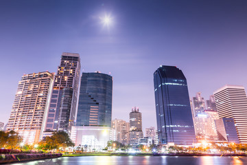 Obraz na płótnie Canvas Bangkok city downtown at night with reflection of skyline, Bangkok,Thailand