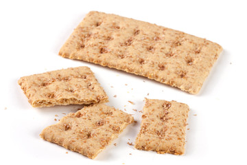 one whole and the broken grain crispbreads isolated on white background