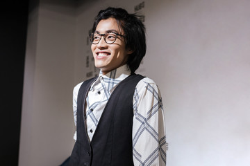 Amazing young asian man looking aside. Coworking concept.