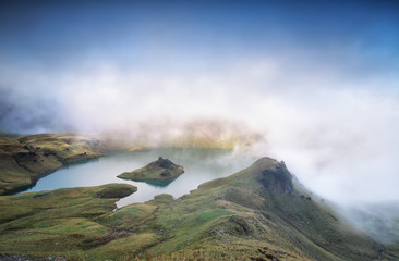 foggy morning on alpine lake