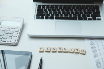 “Planning” crossword on business working table.