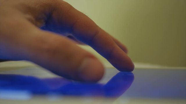 The male hand Approximate and Detach geoposition on the tablet