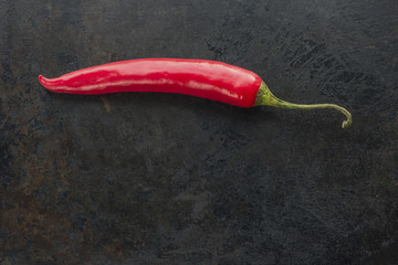 cayenne chilli pepper on rusty metal background. copy space