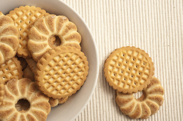 home made cookies buiscuits in a bowl over beige background 