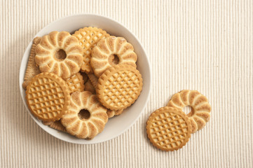 home made cookies buiscuits in a bowl over beige background 