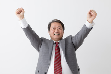 ガッツポーズ、万歳をするビジネスマン、中年男性