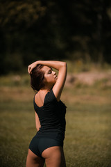 pretty girl performing fitness activities and stretching on the lawn