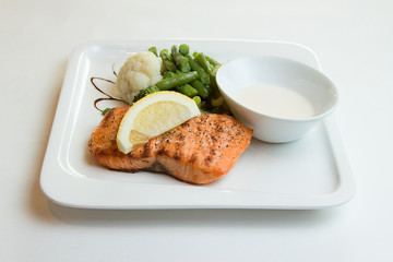Salmon steak grilled with lemon