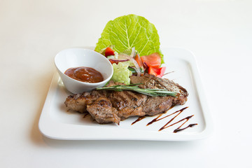 Grilled ribeye beef steak, herbs and spices.