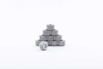 Isolated metal pinions gear. The iron gear on a white background. Pinions in the gearbox. Parts to...