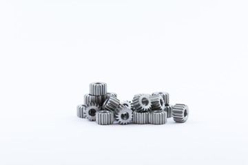 Isolated metal pinions gear. The iron gear on a white background. Pinions in the gearbox. Parts to...