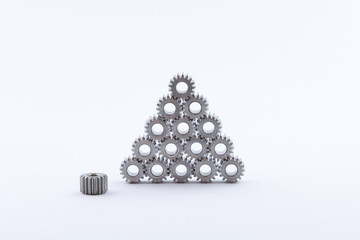 Isolated metal pinions gear. The iron gear on a white background. Pinions in the gearbox. Parts to the gear mechanism. Sprockets to clockwork. Shiny gear ready for assembly. © karelpesorna