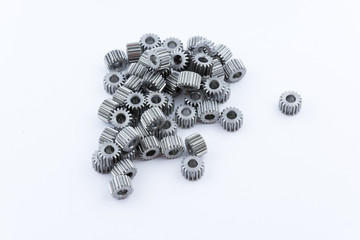 Isolated metal pinions gear. The iron gear on a white background. Pinions in the gearbox. Parts to...