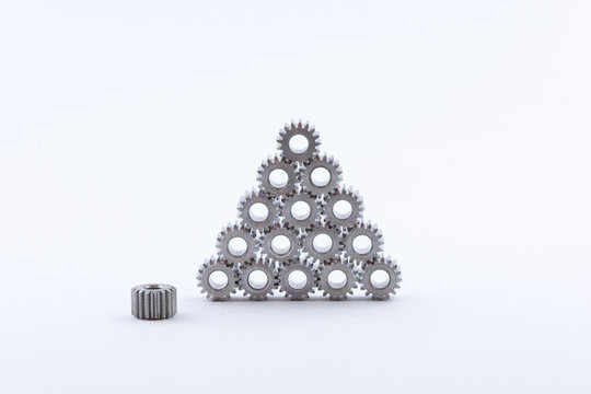 Isolated metal pinions gear. The iron gear on a white background. Pinions in the gearbox. Parts to the gear mechanism. Sprockets to clockwork. Shiny gear ready for assembly.