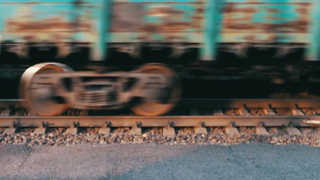 Wheels of the train moving along the rails closeup