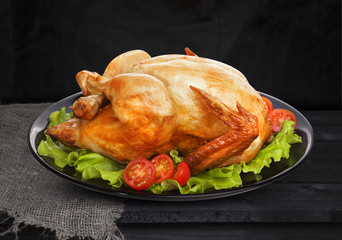 Roasted chicken on black background