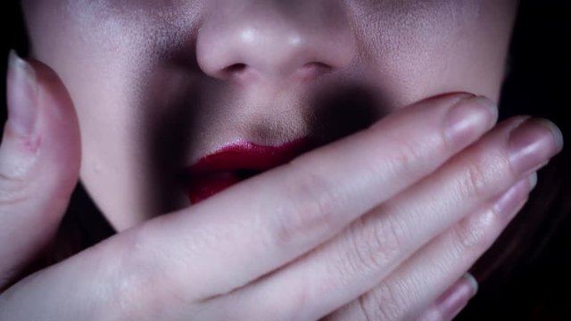 4K Horror Close-Up of Woman Wiping Blood from Lips