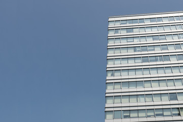 Fototapeta premium Modern Building with Blue Sky Background Copy Space on the Left / Commercial Concept / Growing Business / Risk Management / Success Project /Future Brightened and Big Dream/Corporate Strategy