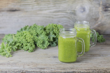 Nutritional smoothie of fresh organic curly green kale with tangerines. Healthy breakfast concept. Fiber for stomach health.