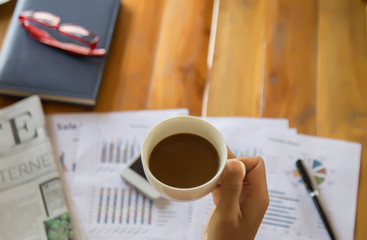 female hands coffee cup on notebook coffee cafe