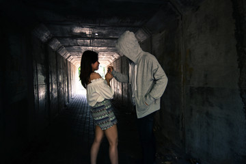 Fototapeta na wymiar Social Issues,Beautiful woman walking in the tunnel and being attack by stalker