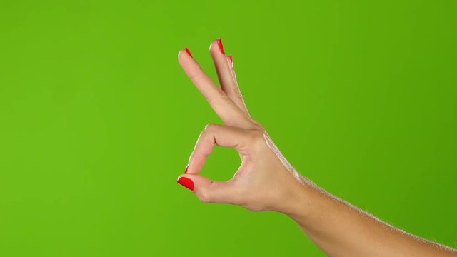 Woman hand shows gesture fingers okay, ok, all right. Studio