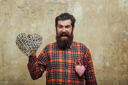 Bearded happy man with two hearts