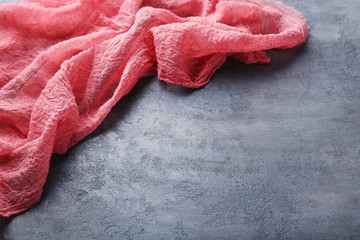 Red gauze fabric on grey wooden table