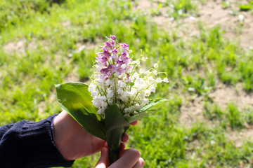 Fototapeta na wymiar Lily of the valley bouquet in hand