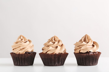 Tasty cupcakes on a white background