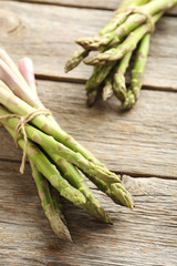 Fresh green asparagus on a grey wooden table