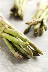 Fresh green asparagus on a grey table