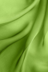 elegant abstract background with diagonal waves  of  green  fabric folds