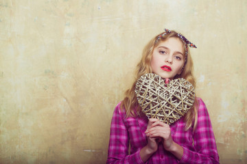 Pretty girl with wicker heart for valentines day