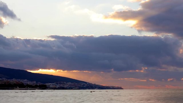 HD scenic sunrise background sun rising. Timelapse of sun rising behing sea and mountains in Nessebar, Bulgaria