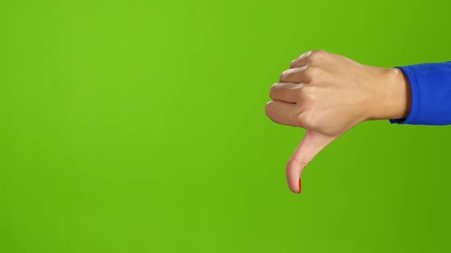 Female hand, sign language. Thumb up and then thumb down