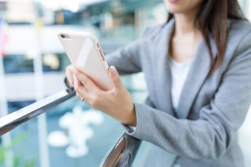 Businesswoman working on mobile phone at outdoor