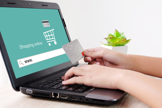Woman hands holding credit card and typing labtop with shopping online www. on search bar background, selective focus, shopping online concept, business and technology